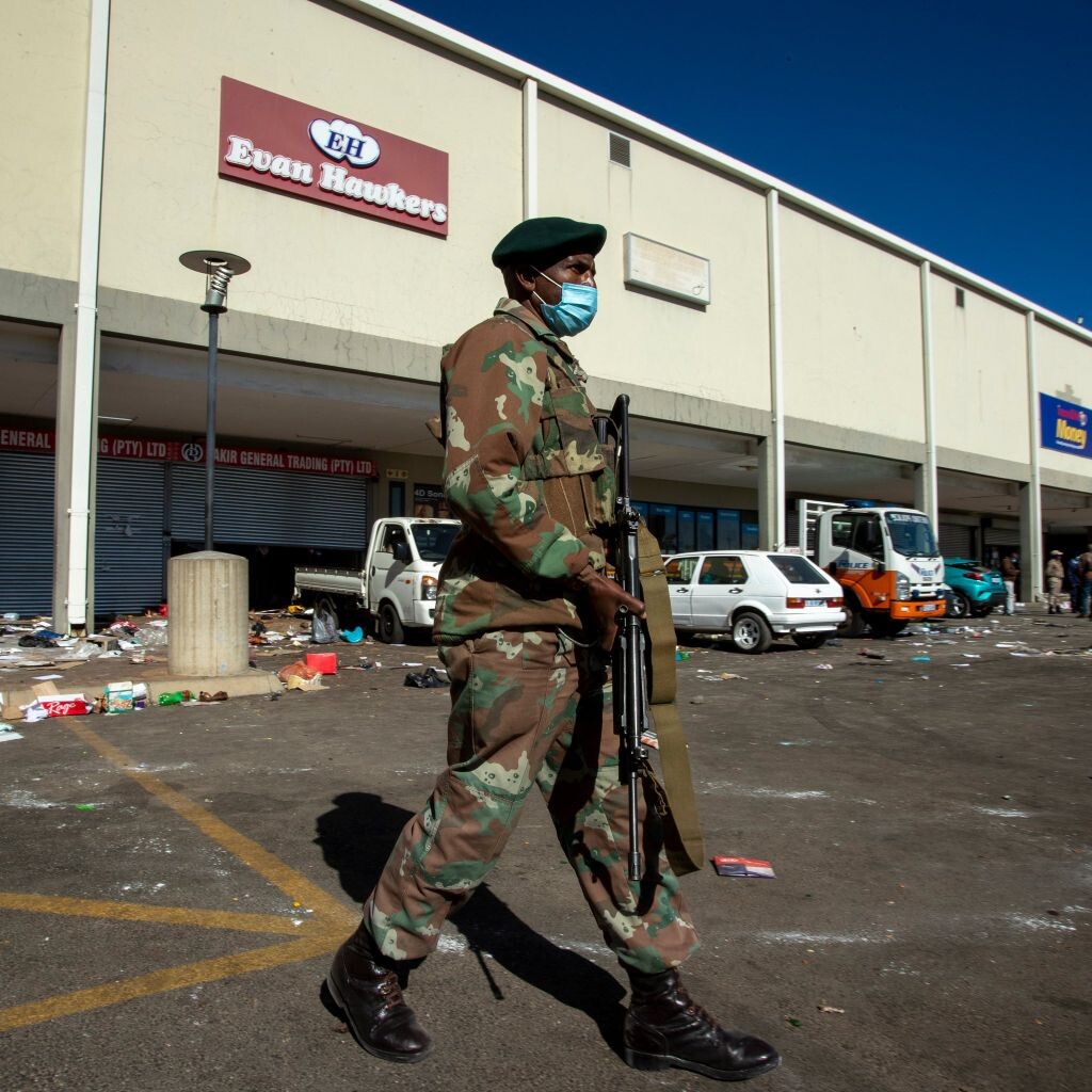 armed soldier guarding an already looted shopping mall in South Africa