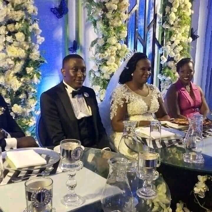 Roger Mugisha sits on high table next to his new wife, Maureen