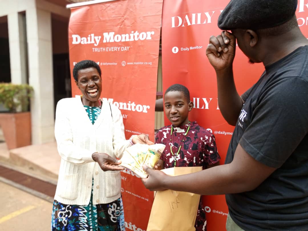 Catherine Ninsiima collects hard cash collected on her behalf from Daily Monitor's offices, Kampala