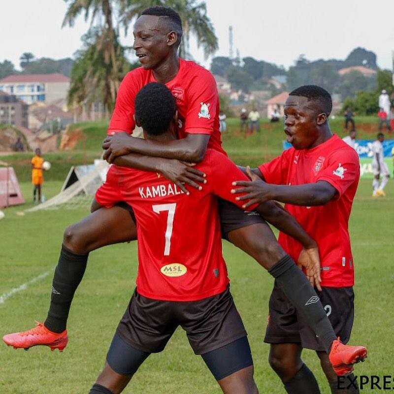 Express FC players celebrate after scoring a goal 